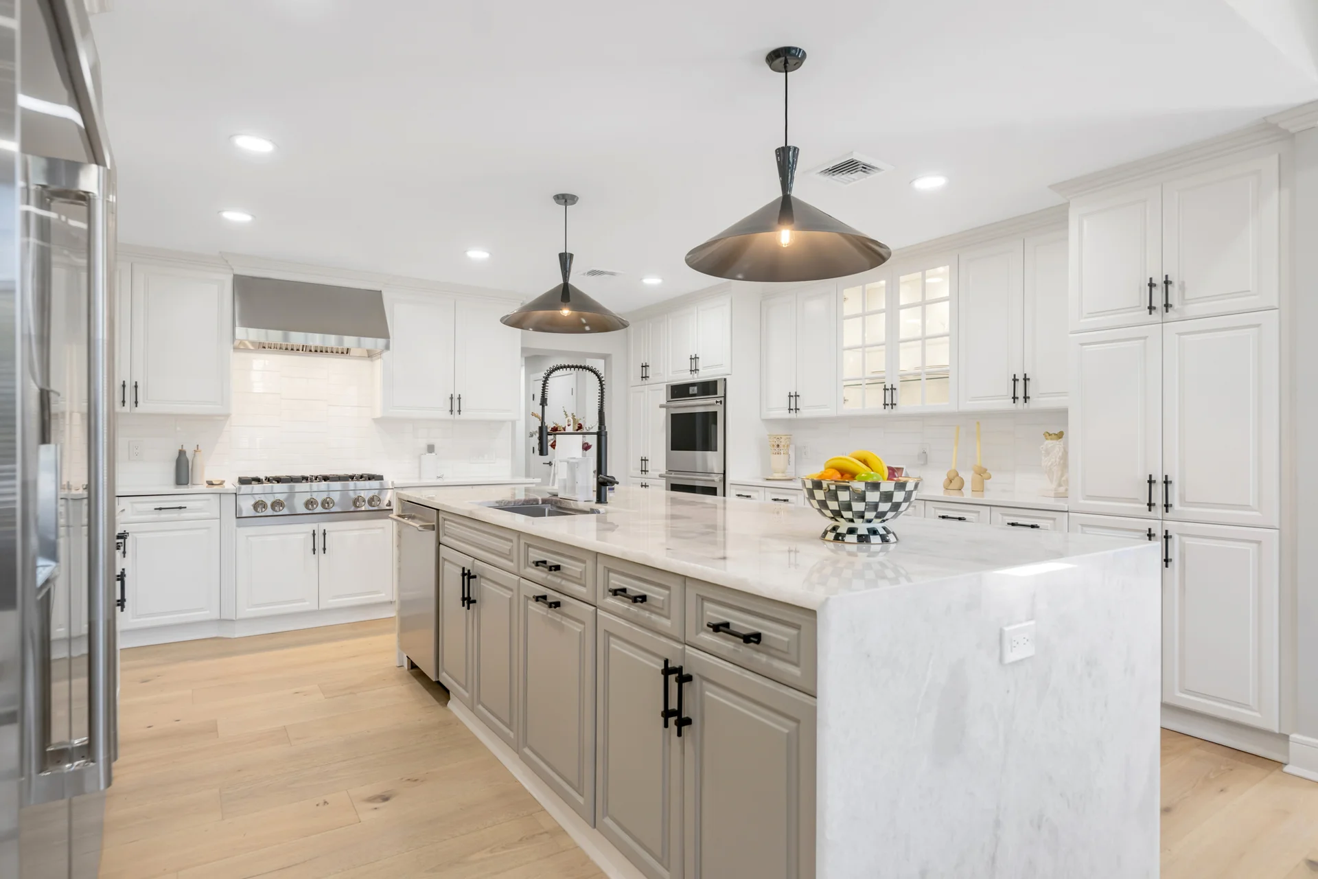 White custom kitchen with marble waterfall island and double ovens — Englewood, NJ