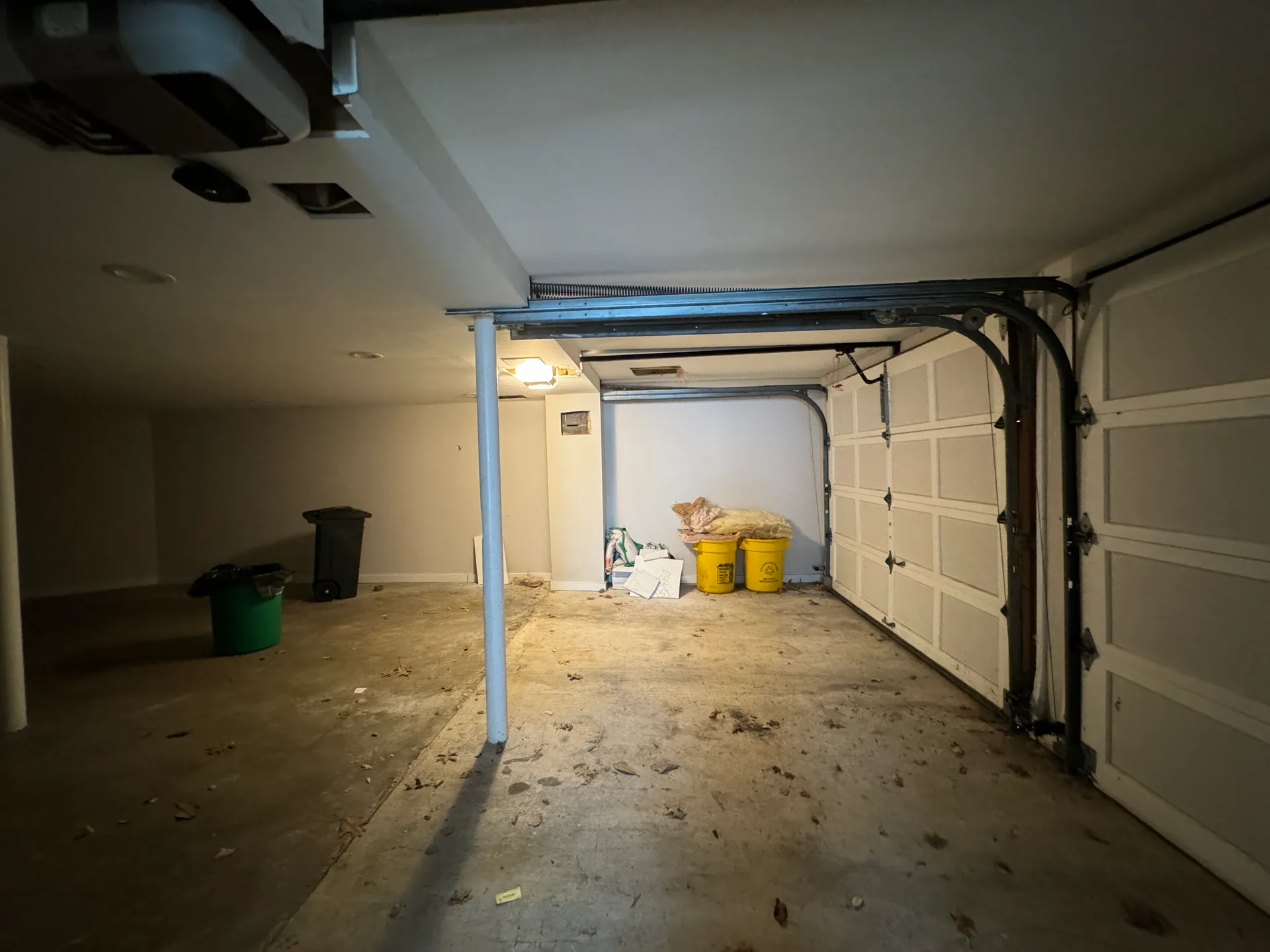 Two-bay garage with bare concrete floor before renovation