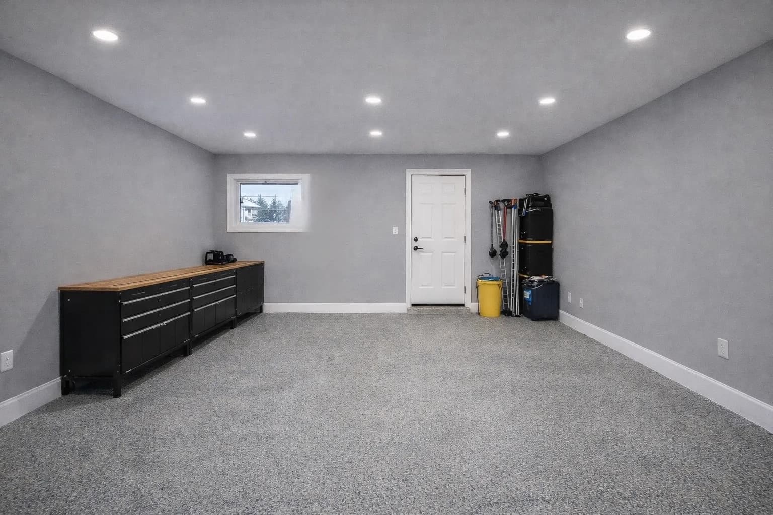Finished garage interior — drywalled, lit, with built-in workbench