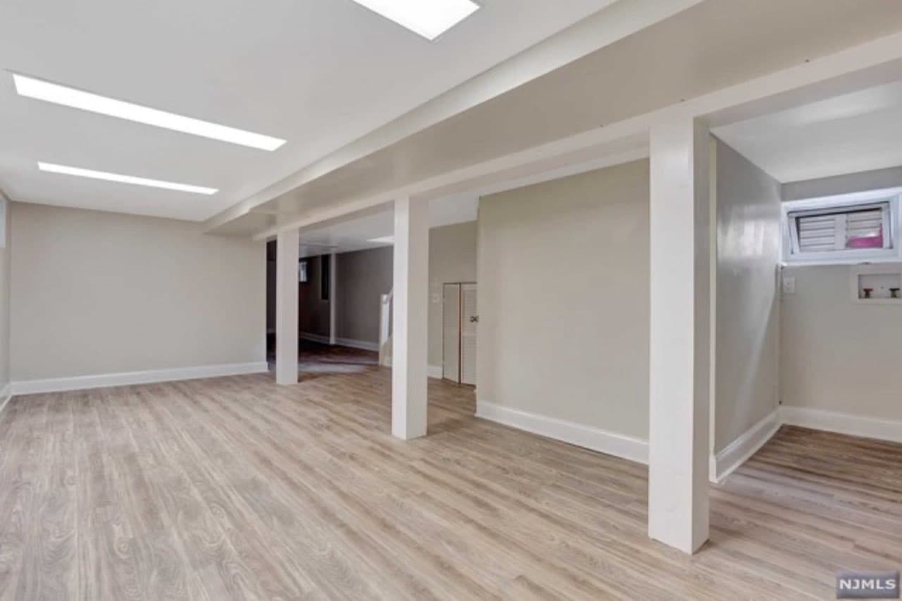 Finished basement with recessed lighting and new flooring