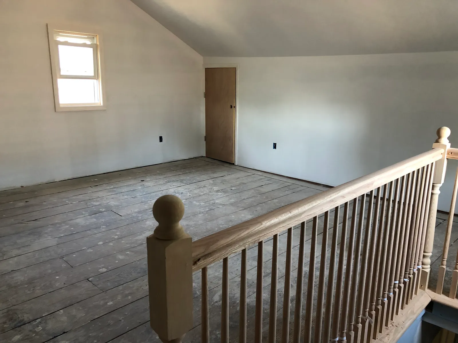 Attic level before renovation — unfinished floors and walls