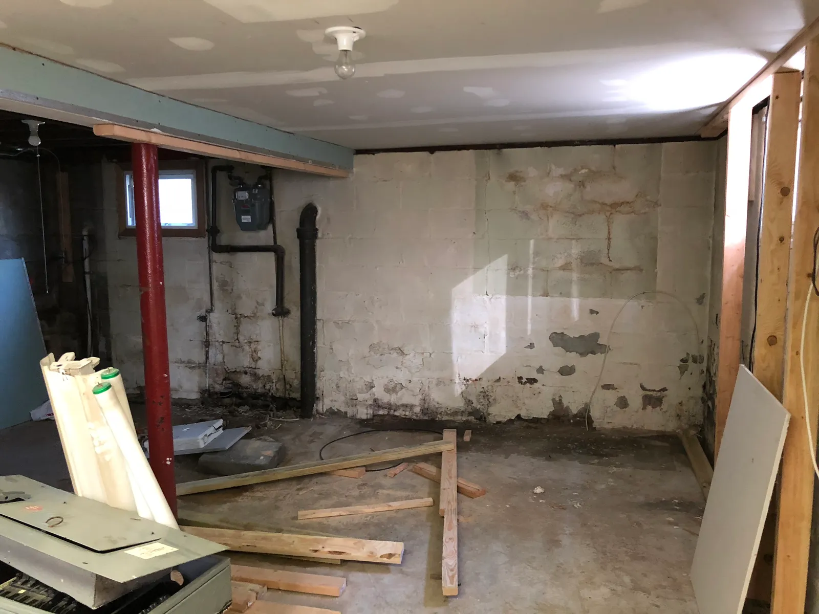 Basement before renovation — exposed foundation and debris