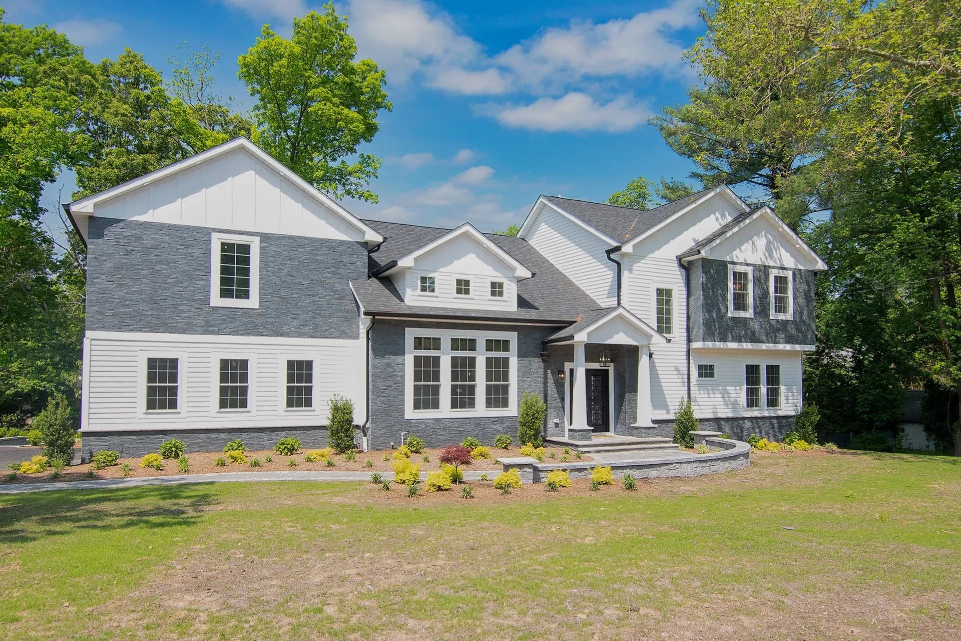 Finished custom home — modern farmhouse exterior with landscaped front yard