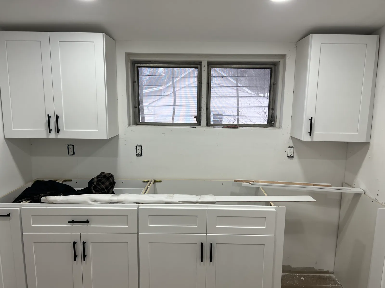 Kitchen mid-install — cabinets set, counters pending