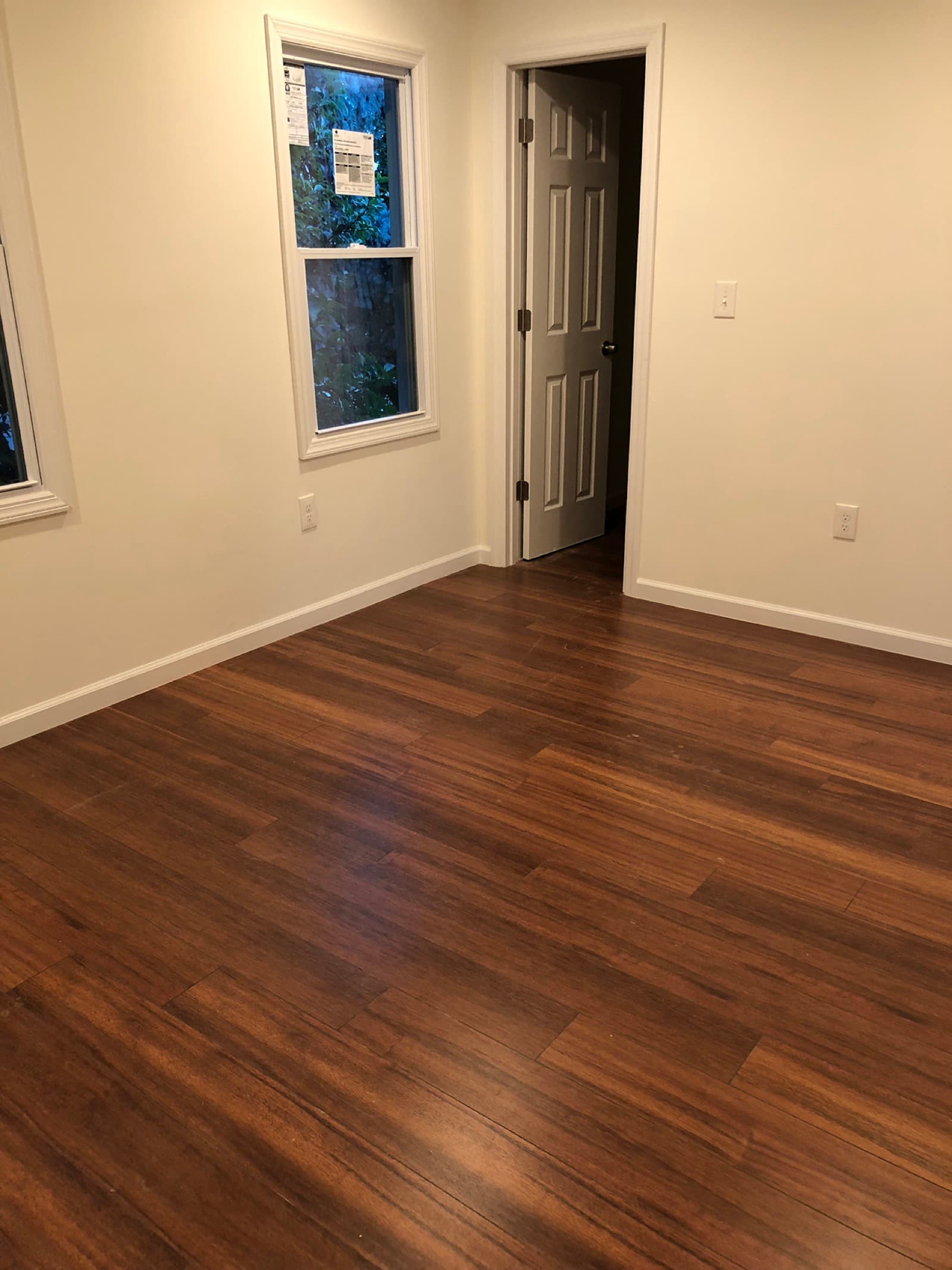 Refinished bedroom — new hardwood flooring, trim, and paint
