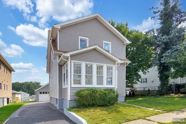 Whole-home renovation — Elmwood Park, NJ — new exterior siding and sunroom