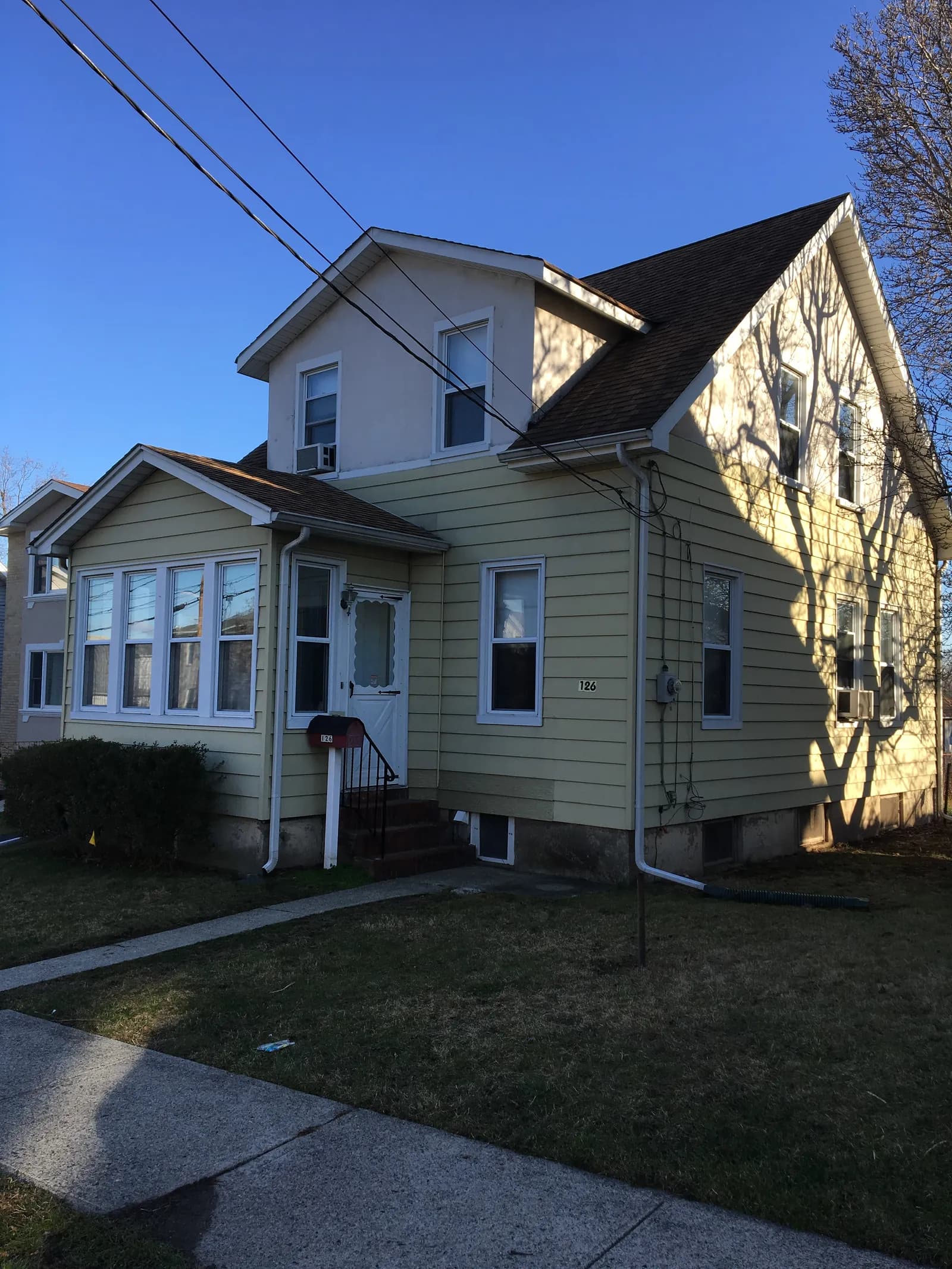 Elmwood Park home before renovation — original yellow siding