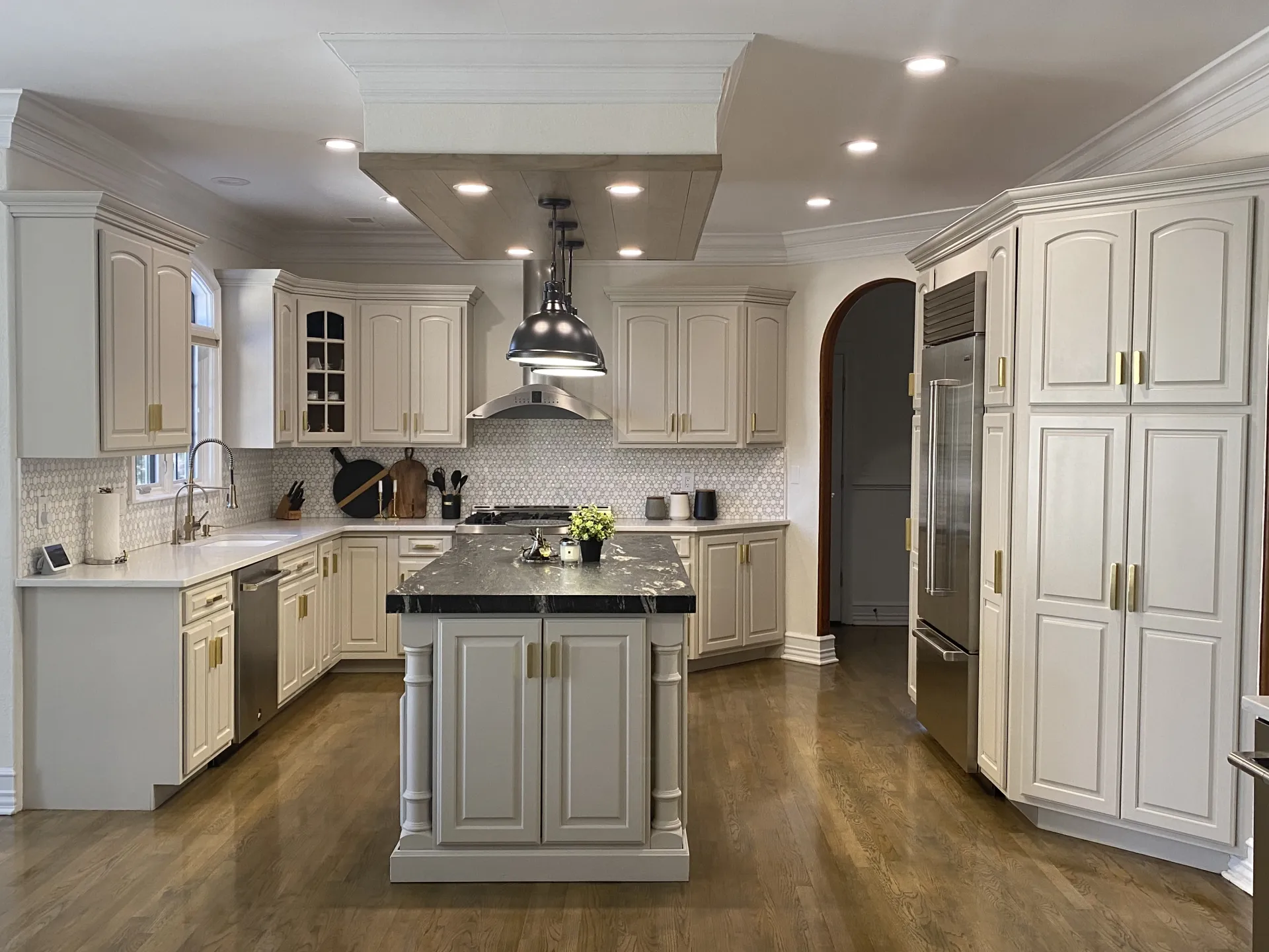 Wyckoff kitchen after renovation — refinished cabinetry, new island, and updated lighting