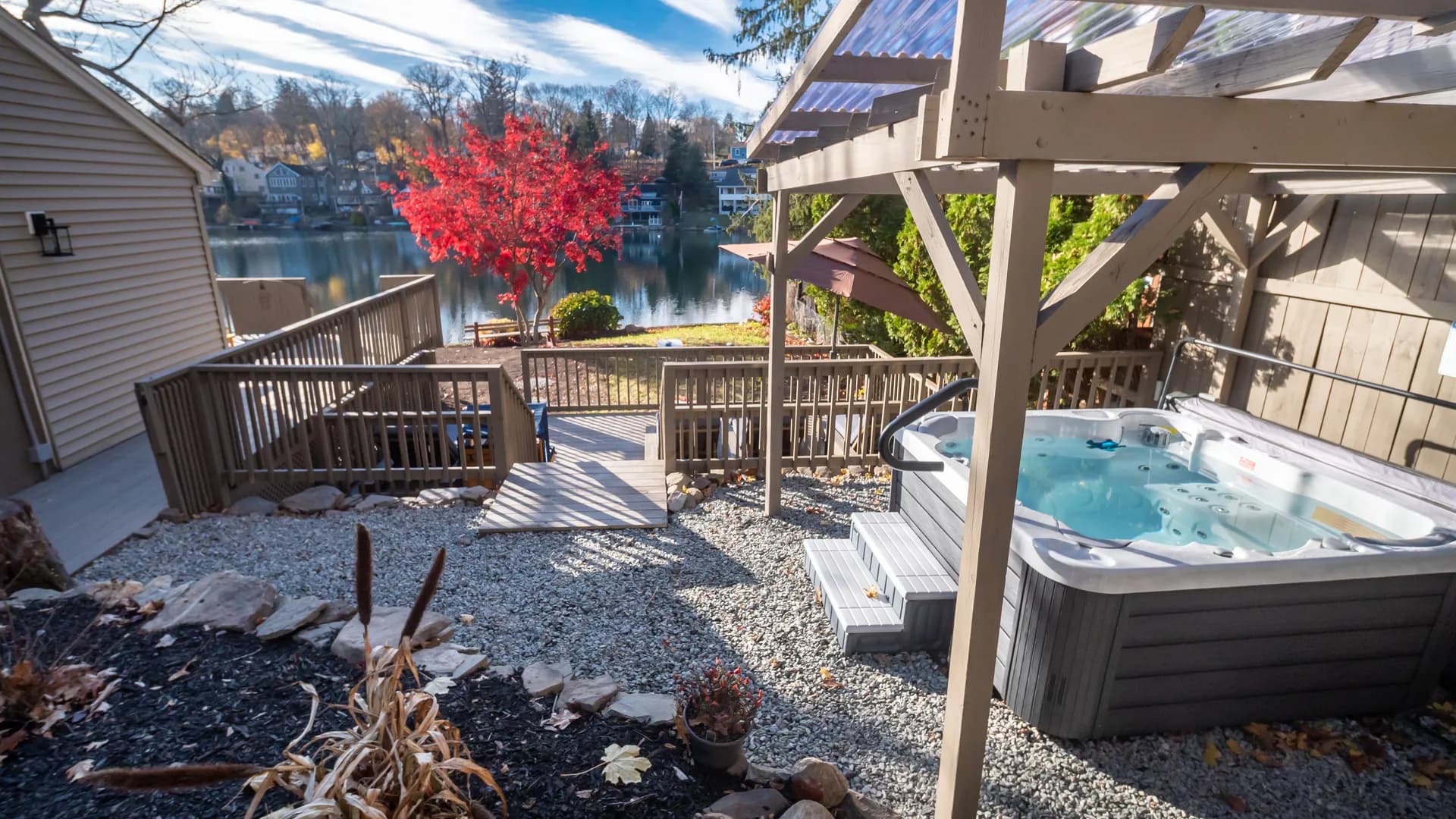 Finished hot tub deck with pergola overlooking the lake